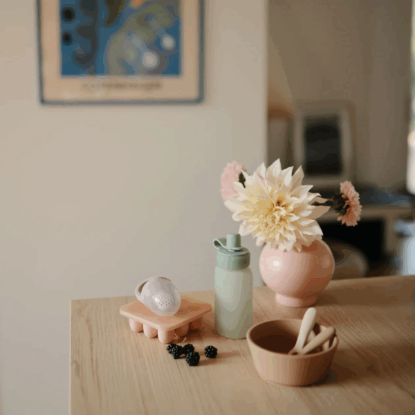 Poche Mushie teinte Blush remplie de purée, usage alimentaire bébé